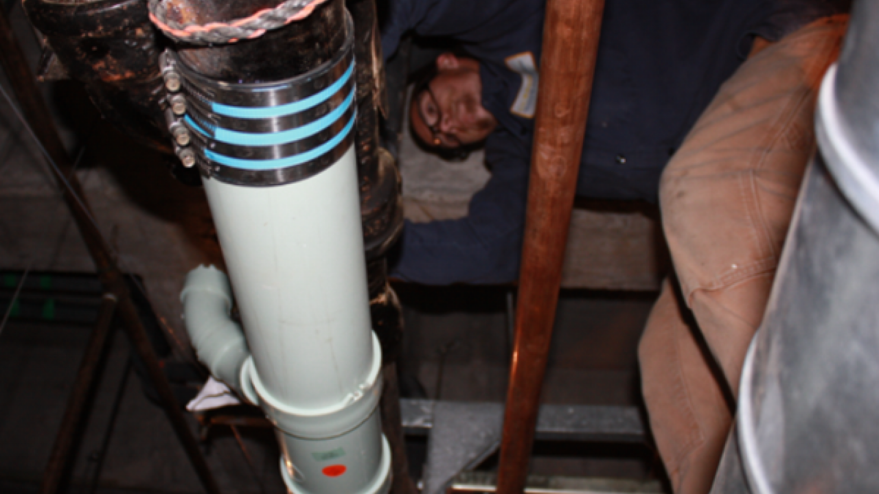 Photo of plumber at work.