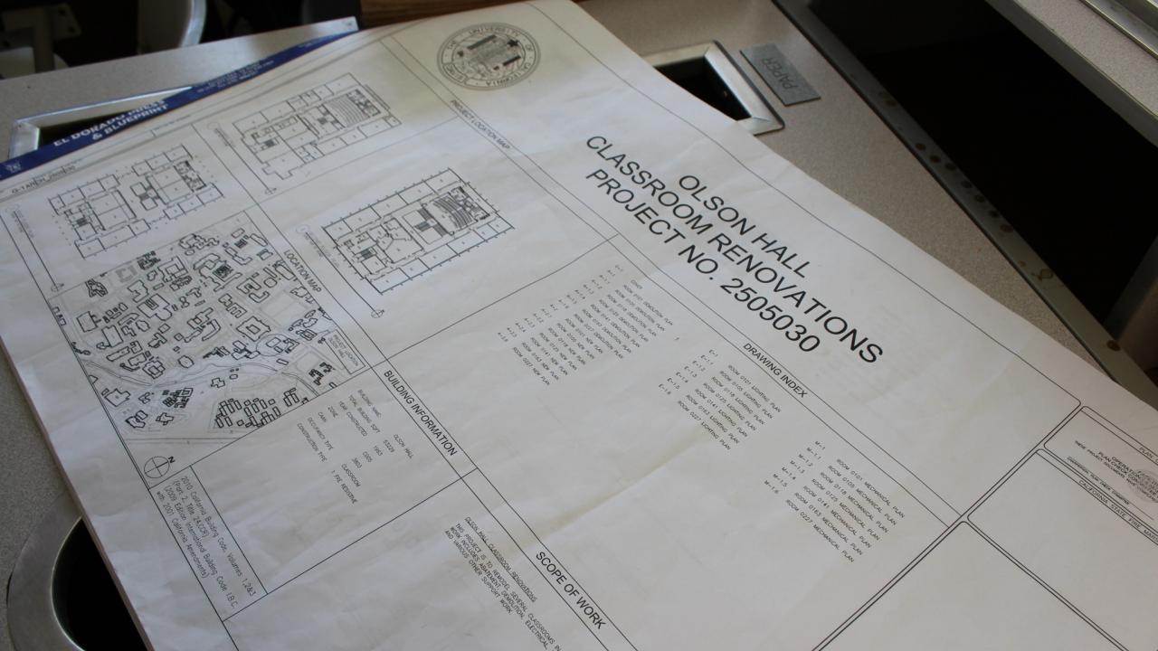 Photo of blueprints for Olson project.