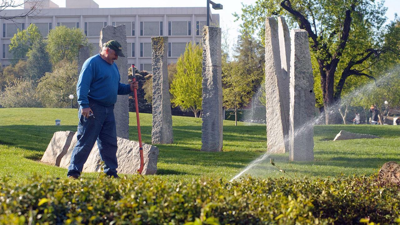 Photo of groundskeeper at work.