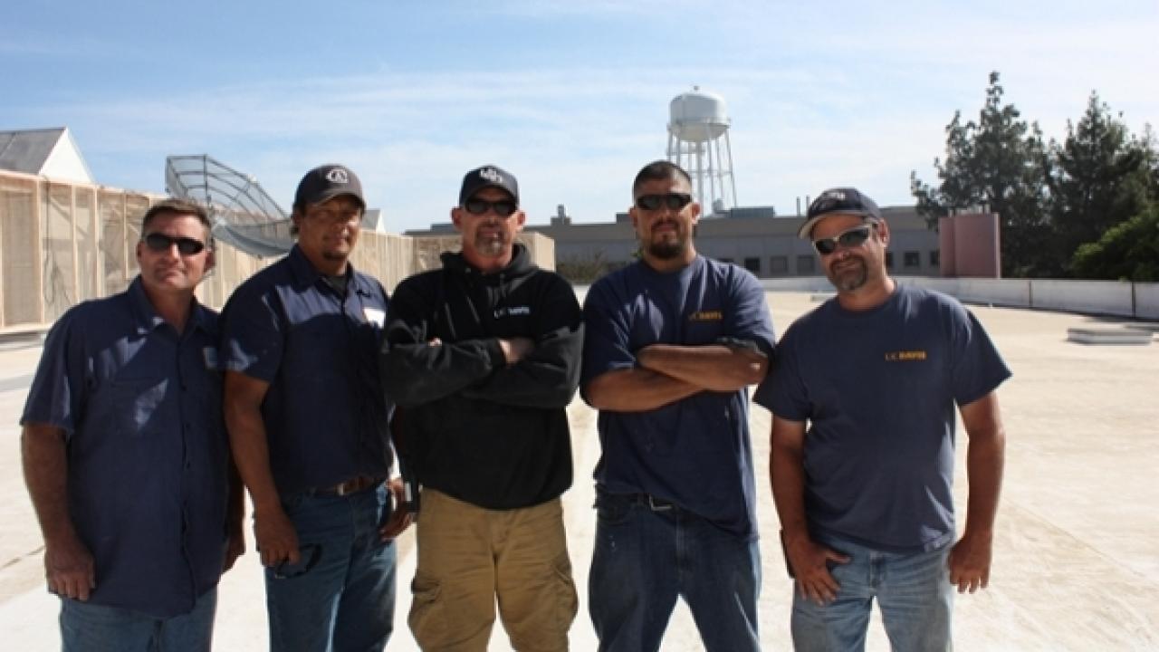 Roofing employees posing for photo.