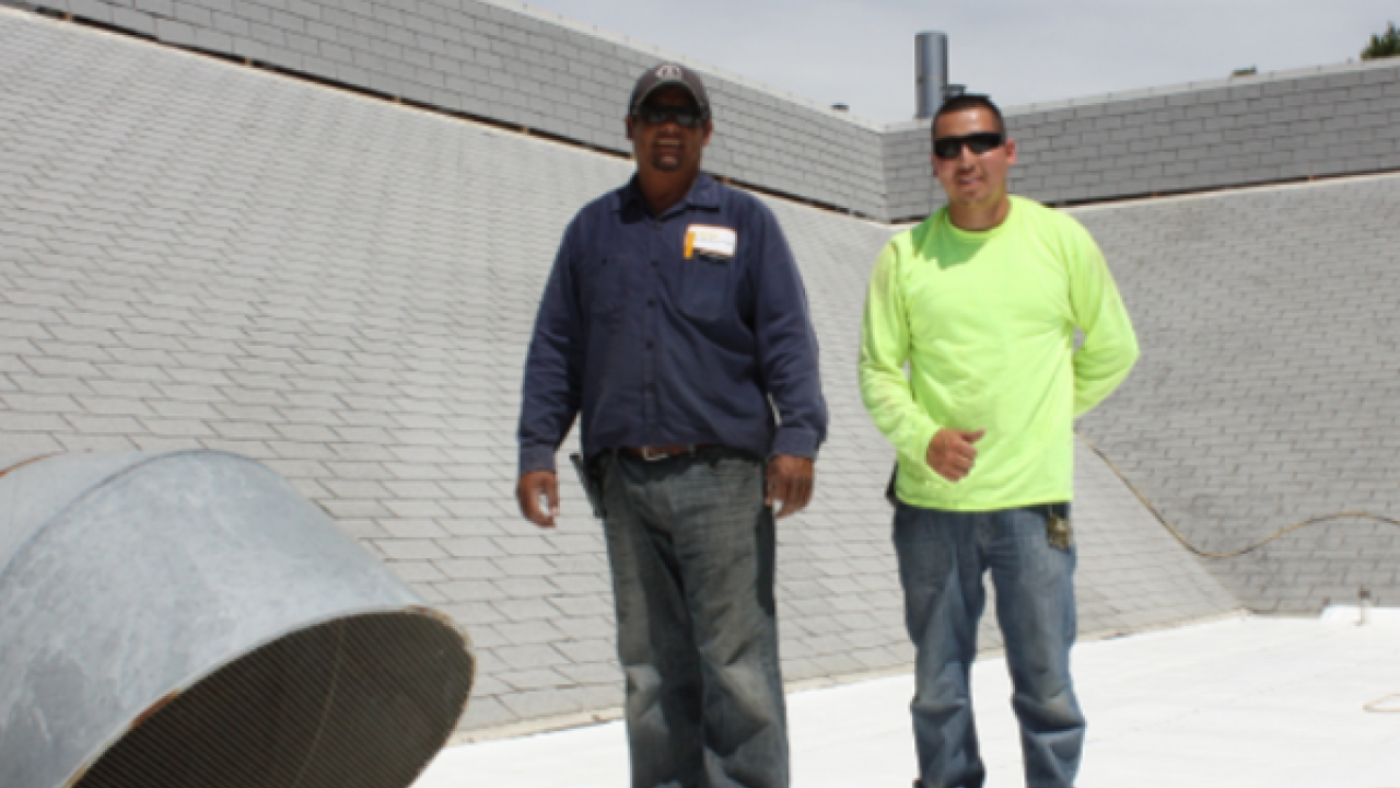 Photo of workers standing on roof.