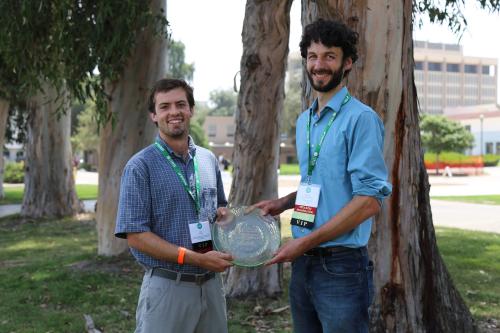 Two members of the SWARM team receive an award.