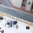 Birds eye view of facilities staff working on a roof on campus.