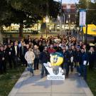 Dozens of people pose for a group photo at a Safety Lighting Walk