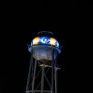 Image of UC Davis' Touchdown Tower at night with the CA logo lit with blue and gold LED lights.