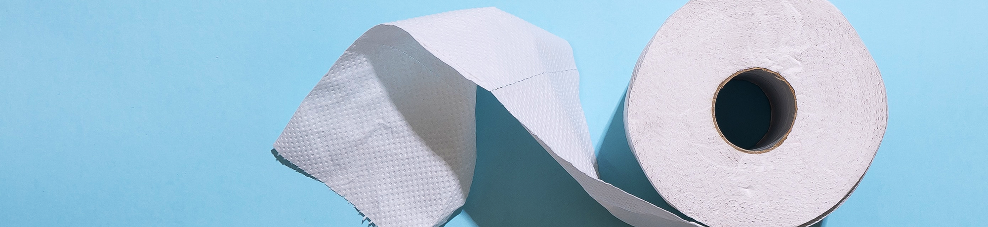 top-view of toilet paper on blue background