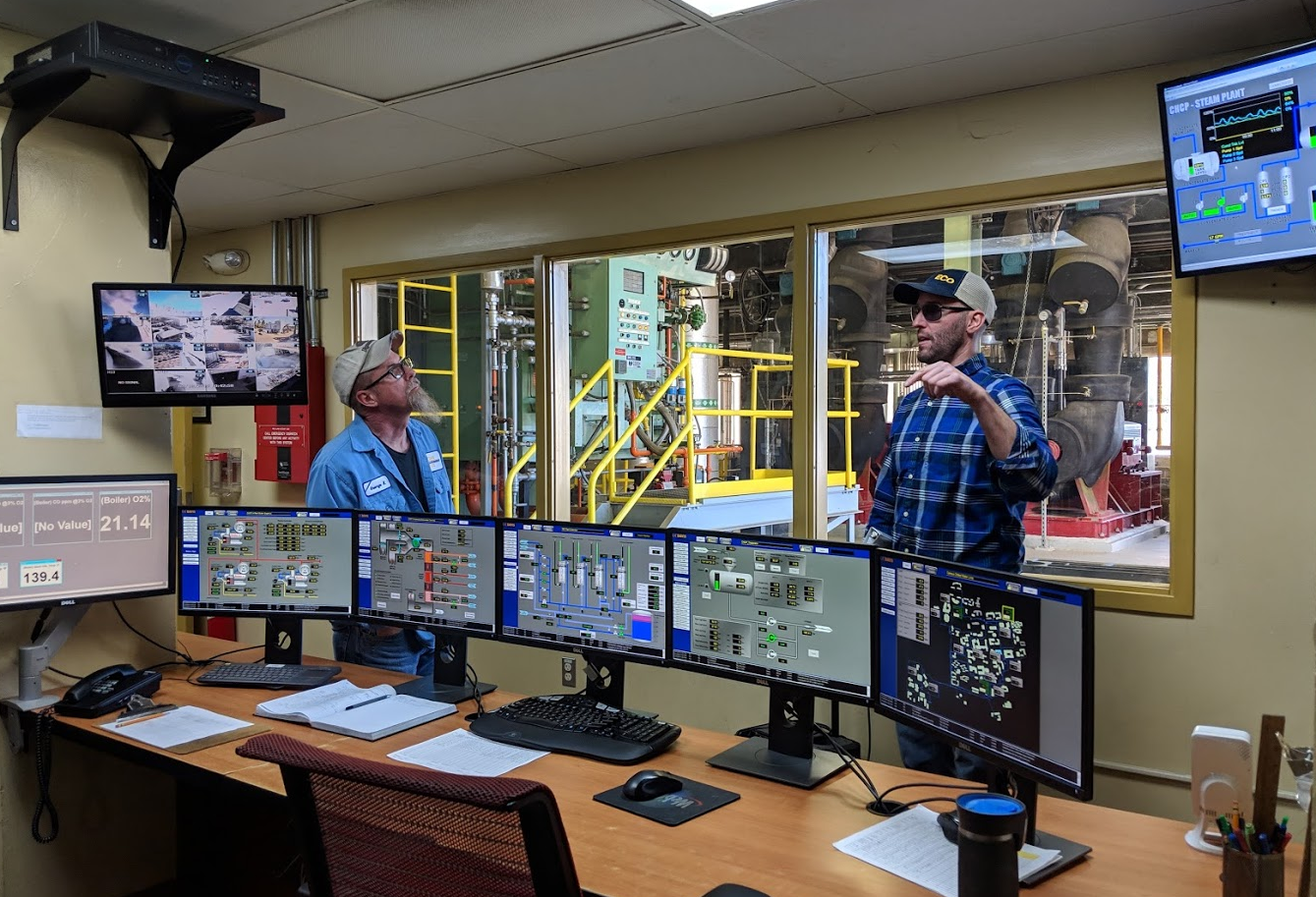 Energy Project Manager Tom Ryan shows a tour group how the CHCP is monitored.