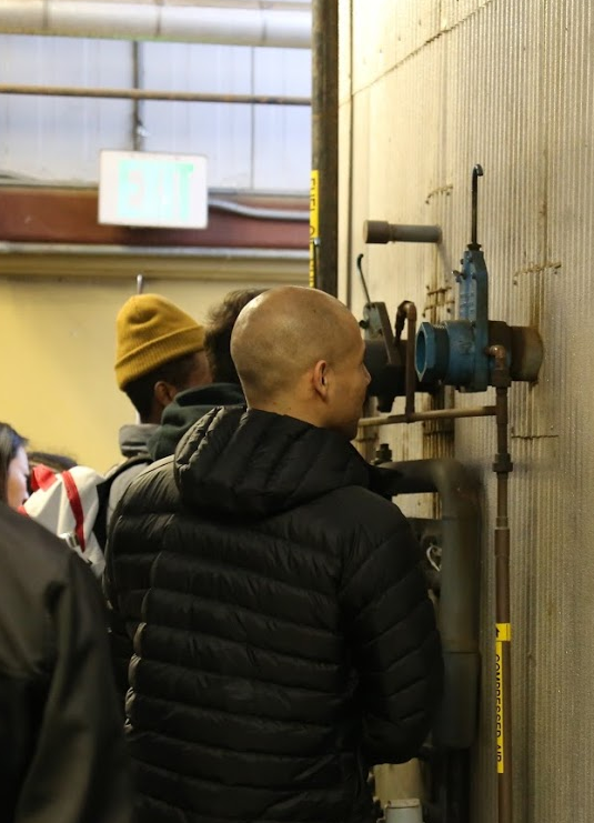 A student looking into the boiler.