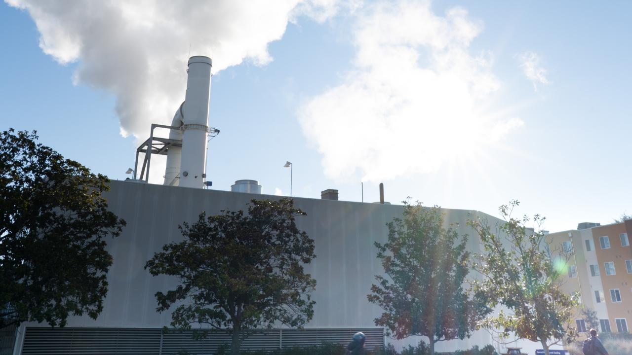Image of UC Davis Central Heating and Cooling Plant with steam rising from stacks.